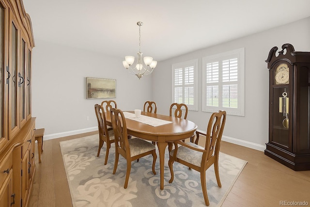14672 Melco Ave, Parker, CO 80134 - dining room featuring a chandelier, light wood-type flooring, and baseboards