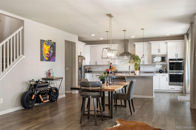 dining space with dark hardwood / wood-style flooring