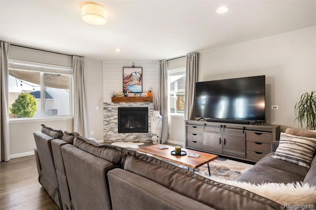 living room with a fireplace and light hardwood / wood-style flooring