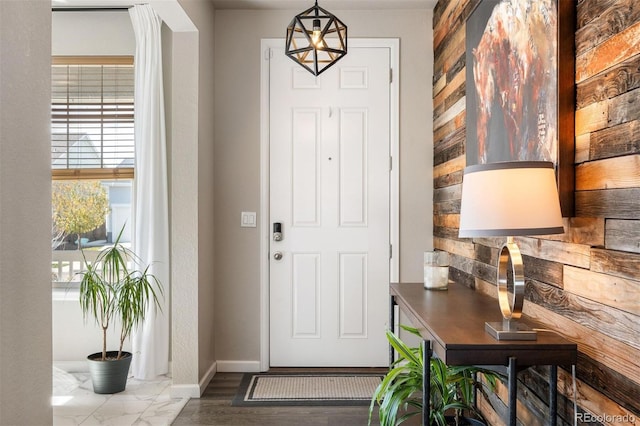 foyer with a notable chandelier and hardwood / wood-style flooring