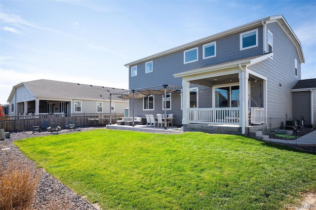 back of house featuring a patio area, outdoor lounge area, a lawn, and ceiling fan