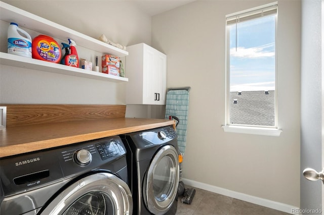 washroom featuring washer and clothes dryer, cabinets, and light tile patterned floors