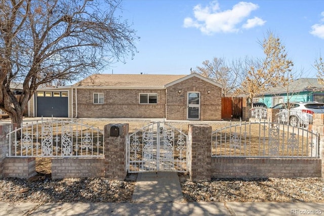 view of front of house featuring an attached garage, a fenced front yard, a gate, and brick siding