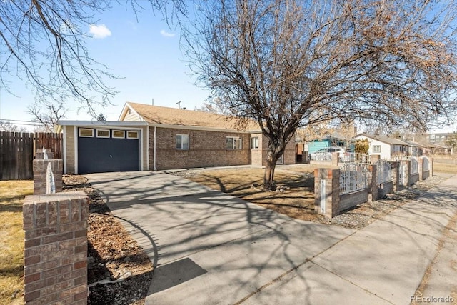 ranch-style home with a garage, driveway, brick siding, and a fenced front yard