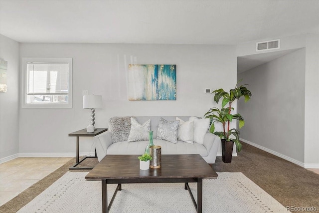 living room featuring visible vents, baseboards, and light tile patterned flooring