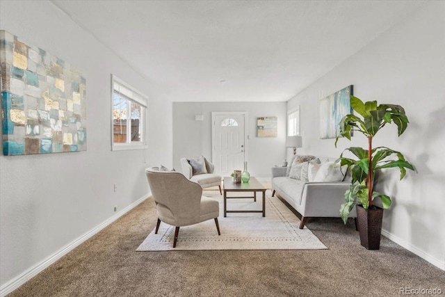 carpeted living room featuring baseboards