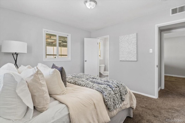 carpeted bedroom with ensuite bath, visible vents, and baseboards