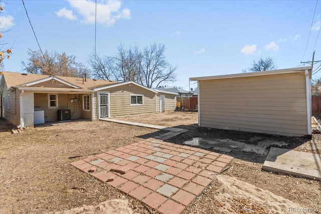 back of property with cooling unit, a patio, and fence