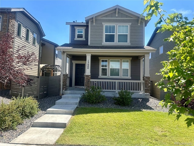 15600 Bolling, Denver, CO 80239 - craftsman-style home with a porch, a front yard, and stone siding