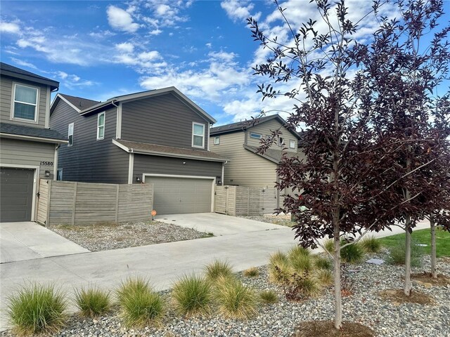15600 Bolling, Denver, CO 80239 - view of property exterior featuring driveway and an attached garage
