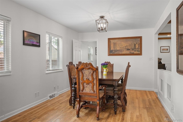 6031 S Pennsylvania St, Centennial, CO 80121 - dining room with a chandelier, light wood-type flooring, and baseboards