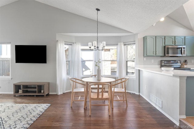 dining area with vaulted ceiling, visible vents, dark wood finished floors, and a notable chandelier