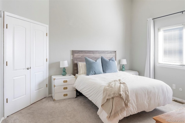 bedroom with visible vents and light colored carpet