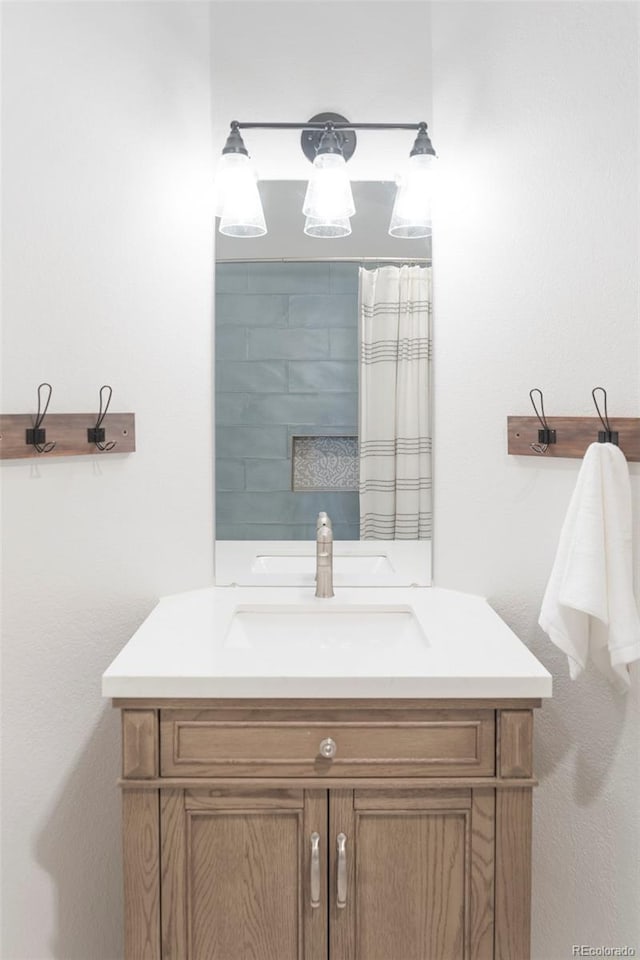 full bathroom featuring curtained shower and vanity