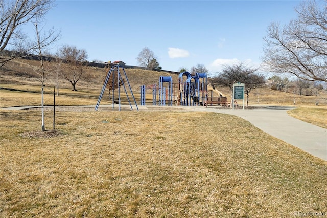 community jungle gym featuring a lawn