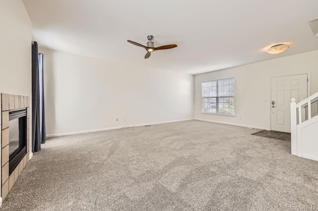 unfurnished living room featuring carpet floors, a ceiling fan, and baseboards