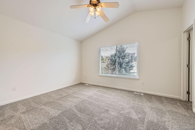 unfurnished room with carpet floors, a ceiling fan, baseboards, and vaulted ceiling