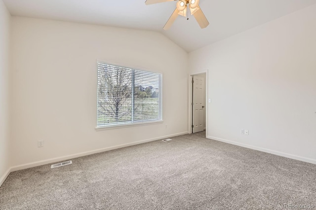 unfurnished room featuring carpet floors, ceiling fan, vaulted ceiling, and baseboards