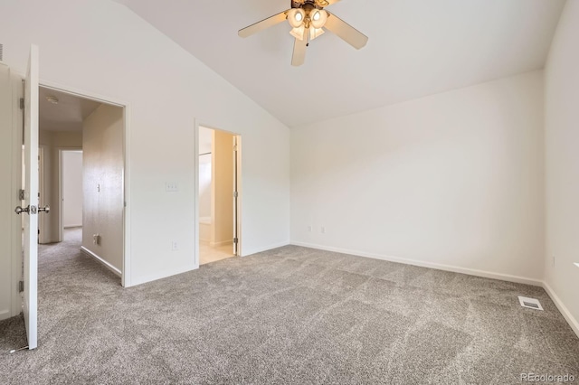 unfurnished bedroom featuring carpet, lofted ceiling, baseboards, ensuite bath, and ceiling fan