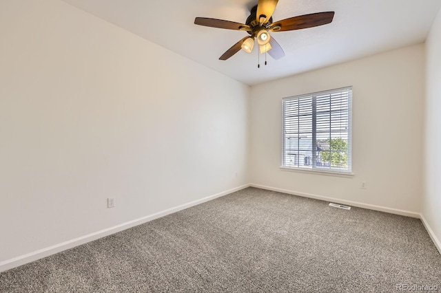 carpeted empty room with baseboards and ceiling fan
