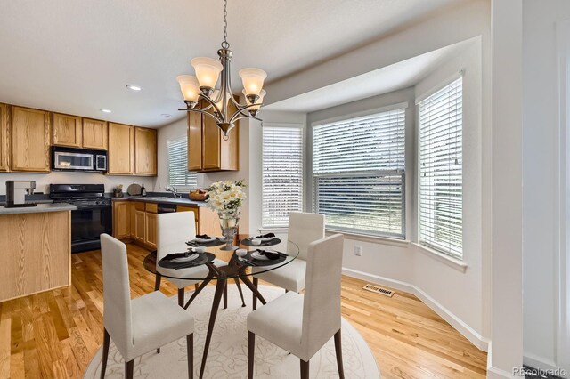 22030 Hill Gail Way, Parker, CO 80138 - dining space featuring light wood-style flooring, a chandelier, baseboards, and recessed lighting