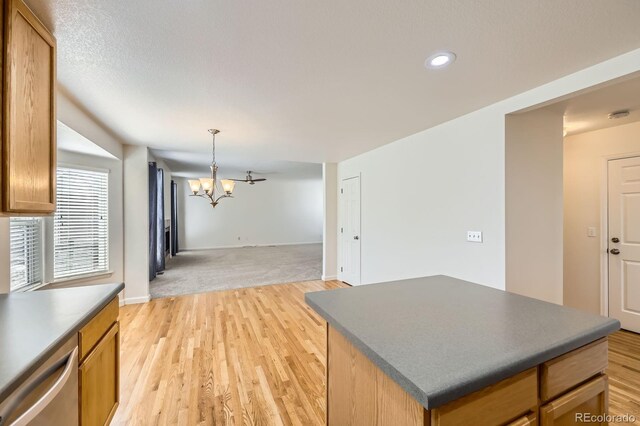 22030 Hill Gail Way, Parker, CO 80138 - kitchen with dark countertops, a chandelier, stainless steel dishwasher, open floor plan, and recessed lighting