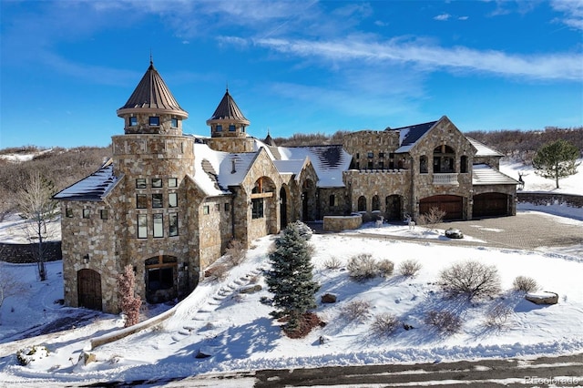 view of front of house featuring a garage and stone siding