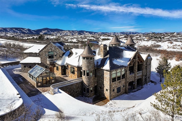 snowy aerial view with a mountain view