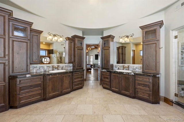 full bath with two vanities, a sink, visible vents, and a shower stall