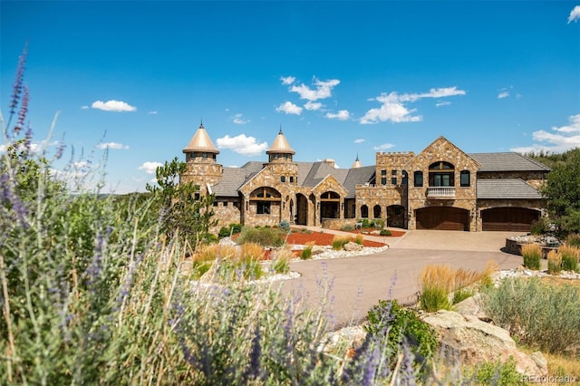 view of property featuring driveway and an attached garage