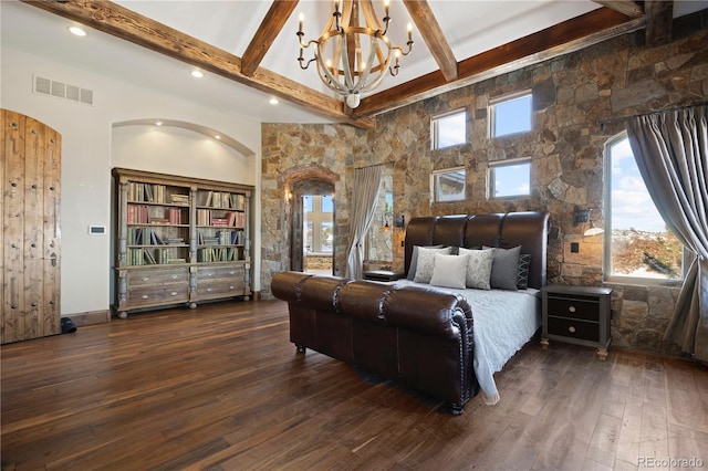 bedroom featuring arched walkways, beam ceiling, visible vents, an inviting chandelier, and dark wood-type flooring