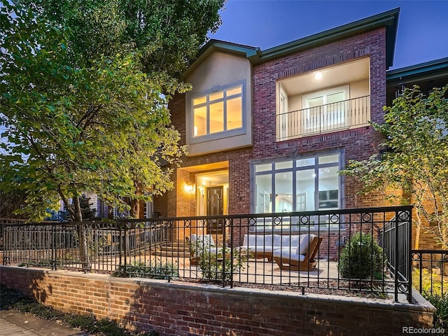 exterior space featuring brick siding and fence private yard