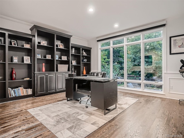 home office with light wood-style floors, ornamental molding, and recessed lighting