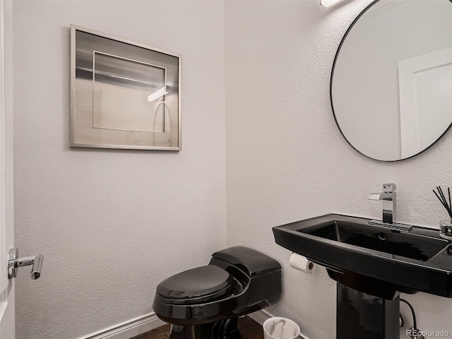 bathroom featuring baseboards and wood finished floors