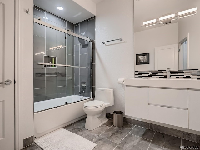 bathroom with vanity, baseboards, toilet, shower / bath combination with glass door, and marble finish floor
