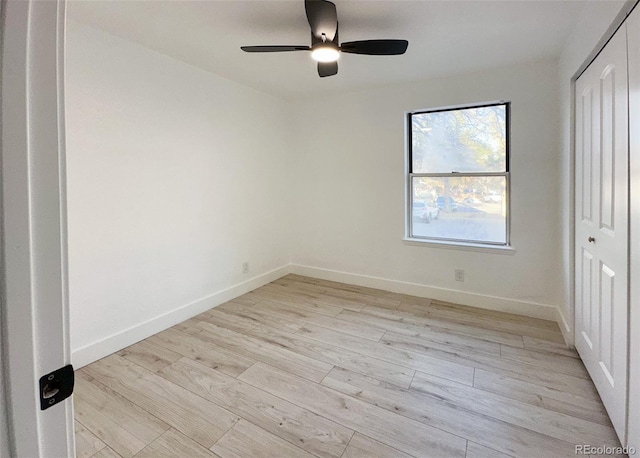 unfurnished bedroom featuring a closet, ceiling fan, and light wood-type flooring