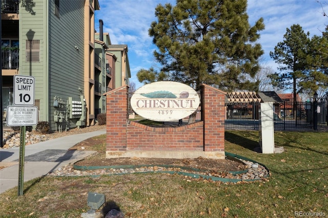 community / neighborhood sign with a yard