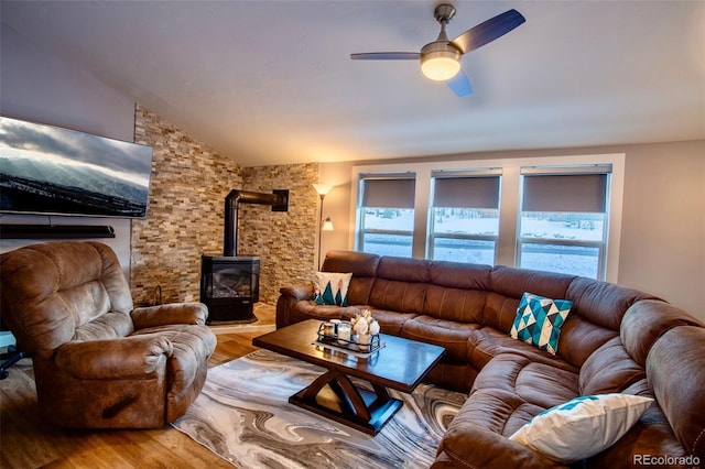472 Ryan Gulch Rd, Silverthorne, CO 80498 - living area with wood finished floors, a wood stove, vaulted ceiling, and ceiling fan