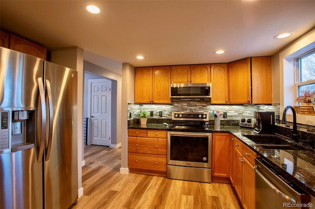 472 Ryan Gulch Rd, Silverthorne, CO 80498 - kitchen with stainless steel appliances, a sink, brown cabinetry, and recessed lighting