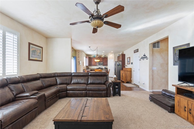 carpeted living room featuring ceiling fan