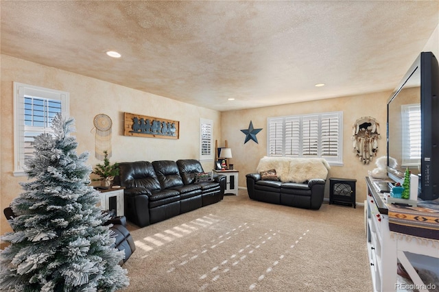 living room featuring light colored carpet and a textured ceiling