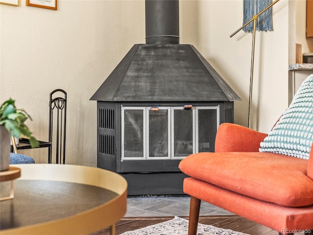 interior space with a textured wall and a wood stove