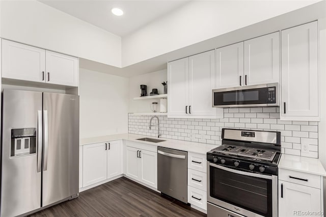 kitchen featuring open shelves, light countertops, appliances with stainless steel finishes, white cabinetry, and a sink