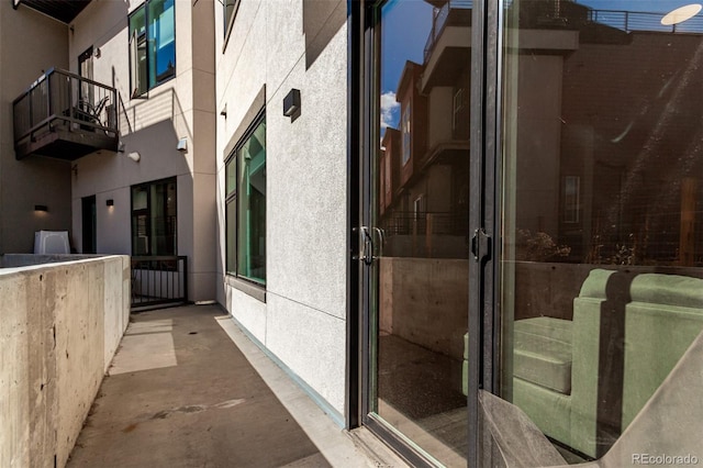 view of home's exterior featuring a balcony and stucco siding