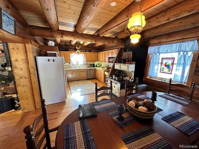 dining room featuring beamed ceiling, light hardwood / wood-style flooring, and wooden ceiling