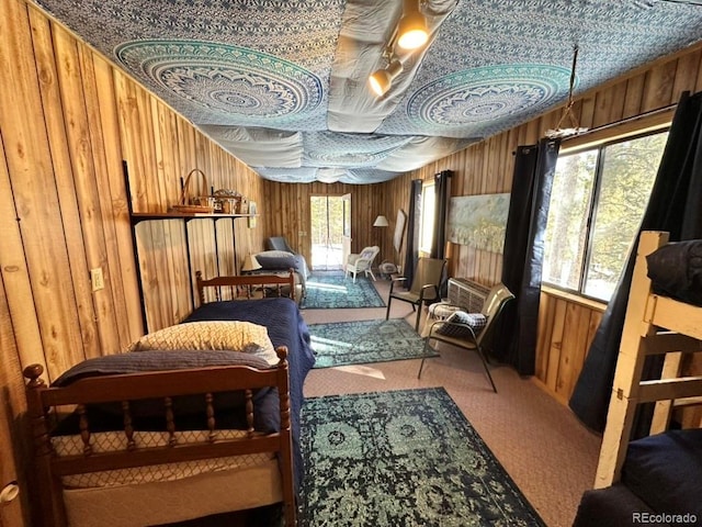 sitting room with wooden walls and carpet flooring