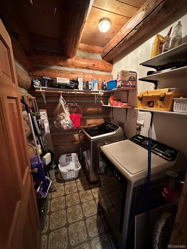 interior space featuring separate washer and dryer, rustic walls, and wooden ceiling