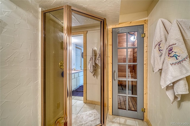 corridor featuring light tile patterned flooring and baseboards