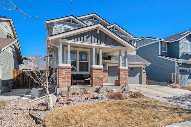 craftsman house with a garage, concrete driveway, a porch, board and batten siding, and brick siding