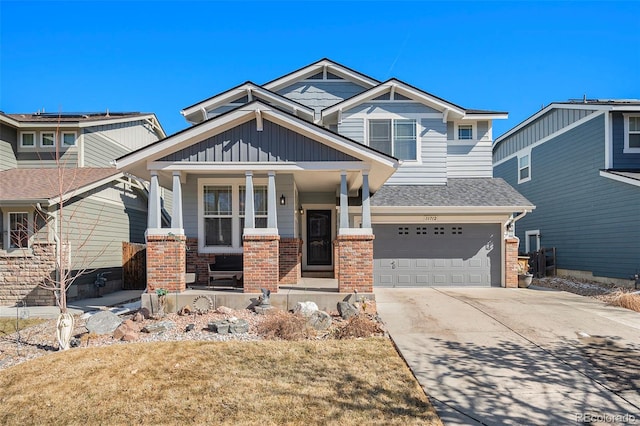 craftsman house with an attached garage, covered porch, brick siding, concrete driveway, and board and batten siding